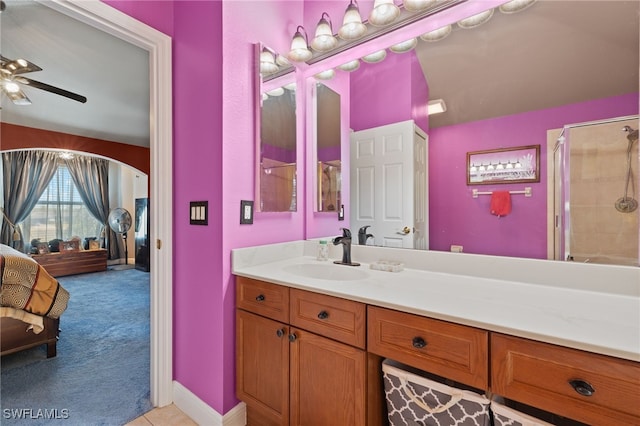 bathroom with vanity, ceiling fan, and a shower with shower door