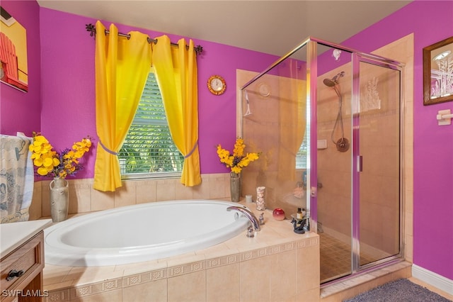 bathroom featuring vanity and separate shower and tub