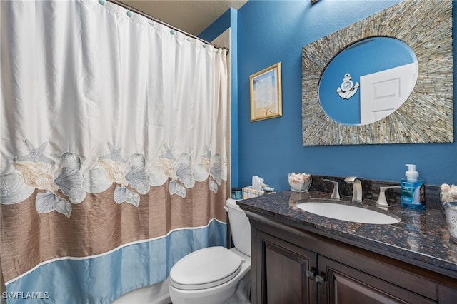 bathroom featuring vanity, a shower with shower curtain, and toilet