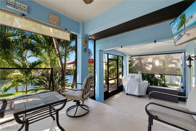 sunroom / solarium with a water view