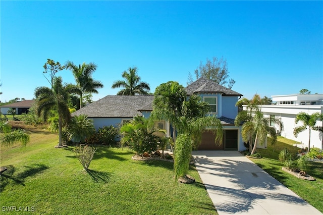 view of front of home with a front yard and a garage