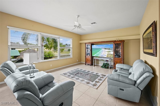 living room featuring ceiling fan and light tile patterned flooring