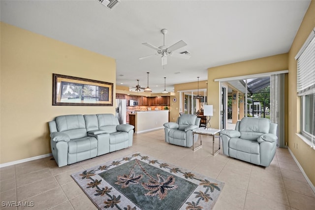 tiled living room with ceiling fan