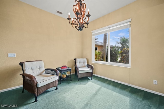 sitting room featuring carpet flooring and a chandelier