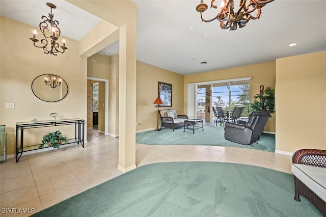 sitting room featuring light carpet and an inviting chandelier