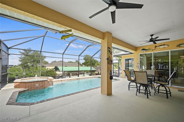 view of swimming pool with an in ground hot tub, pool water feature, glass enclosure, and a patio area