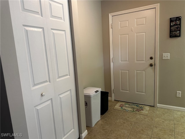 doorway to outside with light tile patterned floors