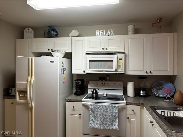 kitchen with white cabinetry, white appliances, and sink