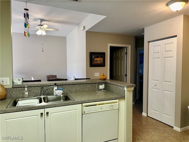 kitchen featuring dishwasher, sink, ceiling fan, light tile patterned floors, and kitchen peninsula