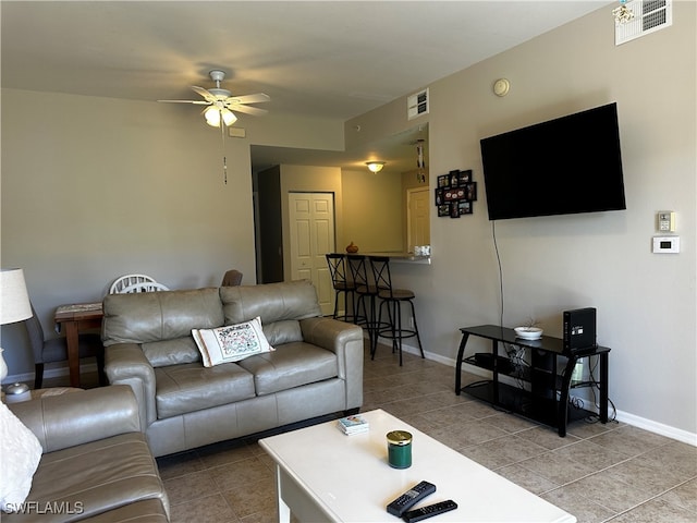 living room with ceiling fan and tile patterned flooring