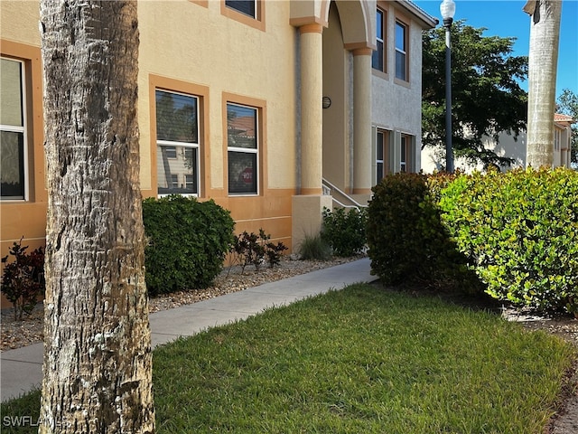 view of property exterior featuring a lawn