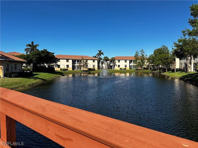 exterior space featuring a lawn and a water view