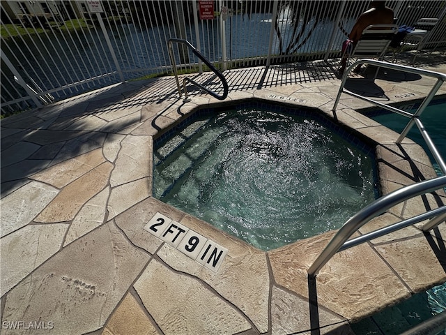 view of pool featuring an in ground hot tub