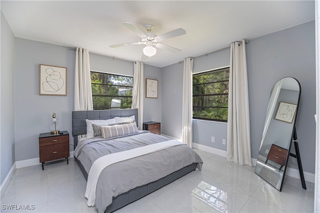 bedroom with multiple windows and ceiling fan