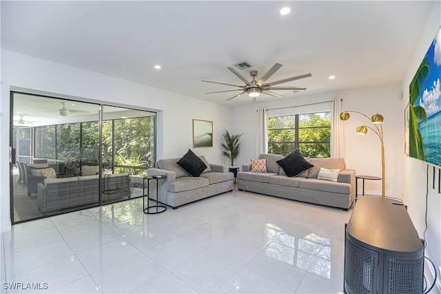 living room featuring ceiling fan and light tile patterned floors