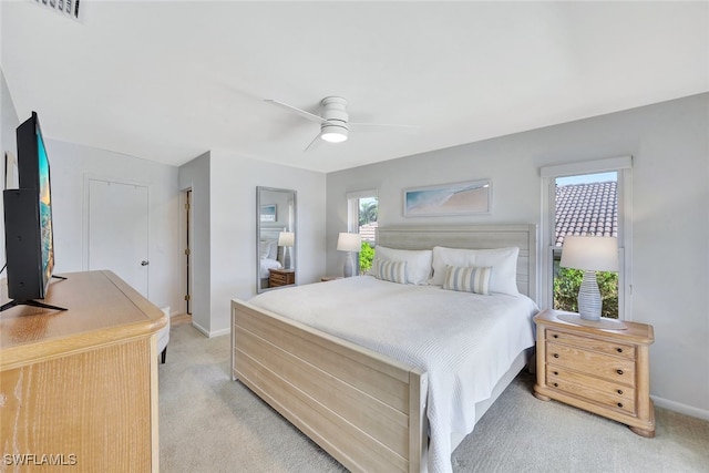 bedroom featuring light colored carpet and ceiling fan