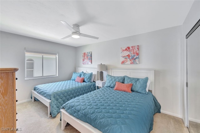 bedroom with light carpet and ceiling fan