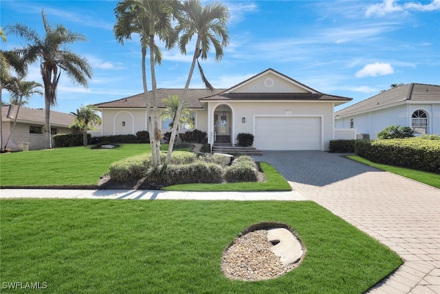 ranch-style house featuring a front yard and a garage