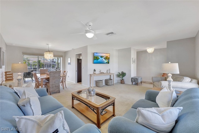 living room with ceiling fan with notable chandelier and light carpet