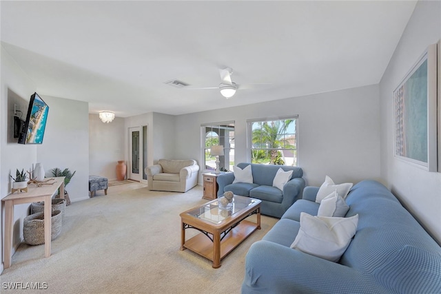 carpeted living room with ceiling fan