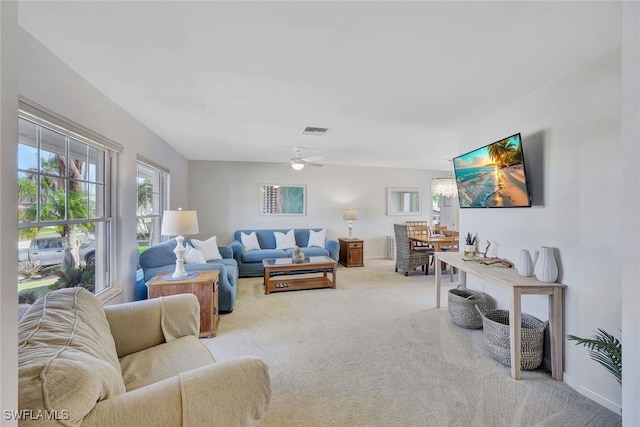 living room featuring carpet floors and ceiling fan