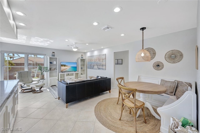 living room with ceiling fan and light tile patterned flooring