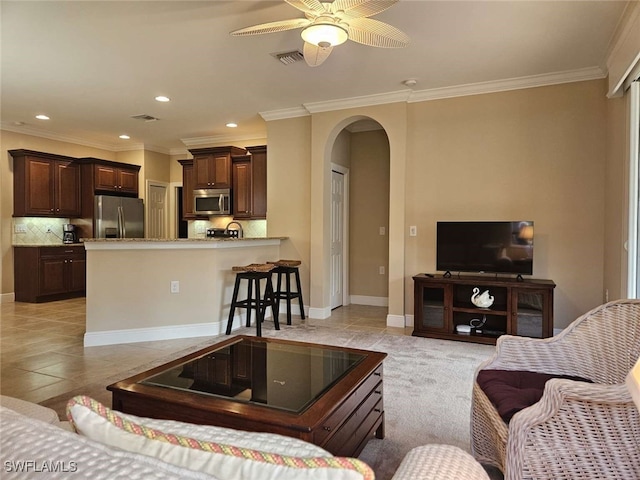 tiled living room featuring ceiling fan and crown molding