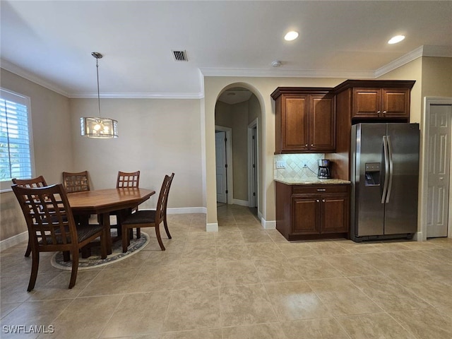 kitchen with light stone countertops, stainless steel fridge with ice dispenser, crown molding, and tasteful backsplash