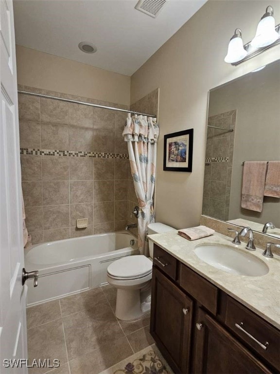 full bathroom featuring tile patterned flooring, vanity, toilet, and shower / bath combo with shower curtain