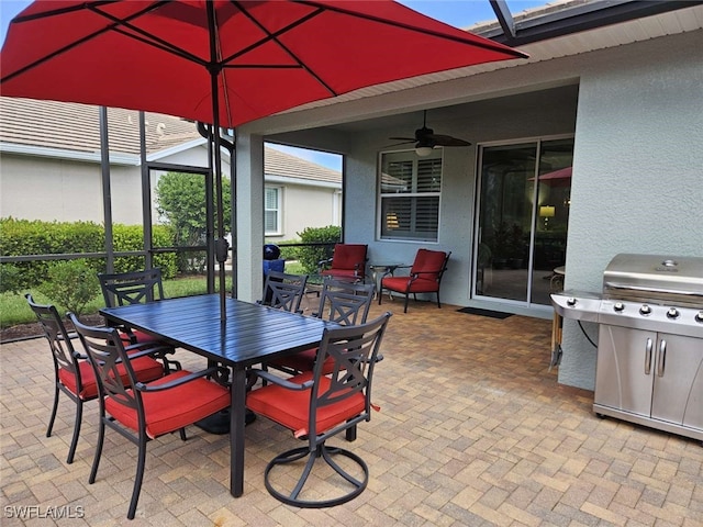 view of patio with a lanai, grilling area, and ceiling fan