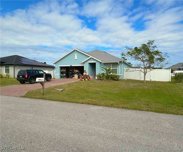 view of front facade featuring a front yard and a garage