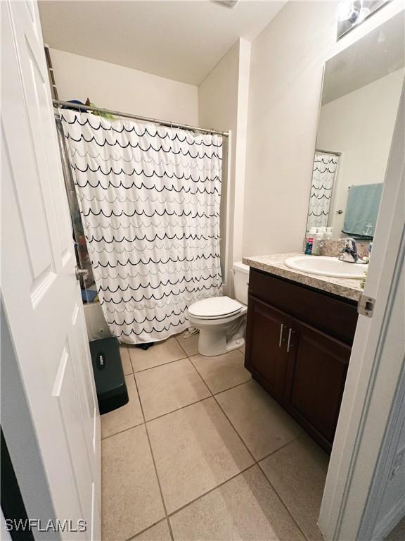 bathroom with tile patterned floors, toilet, and vanity