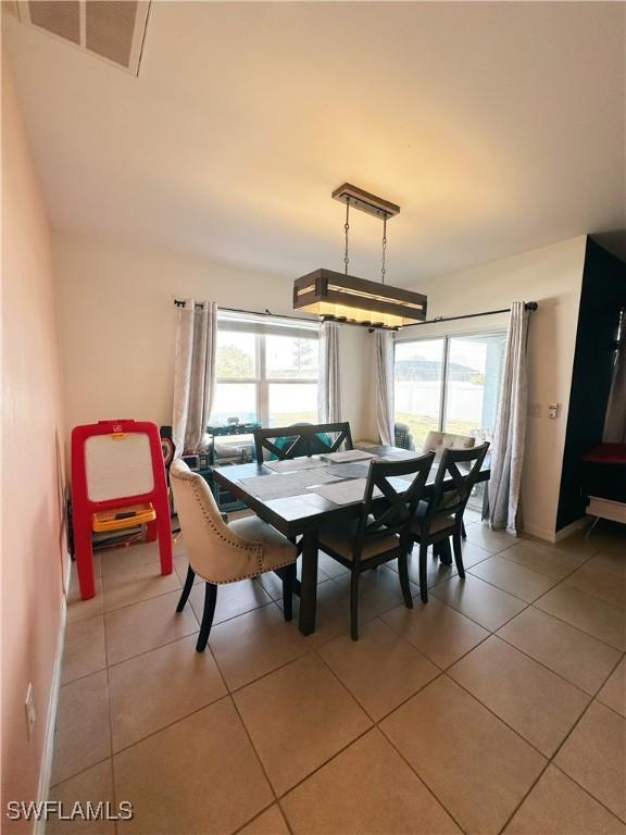 tiled dining space featuring a wealth of natural light