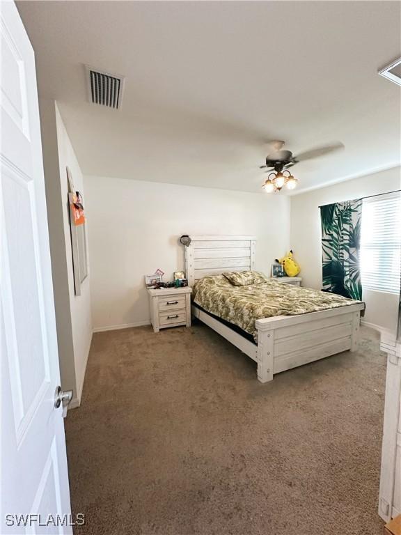 bedroom with ceiling fan and carpet floors