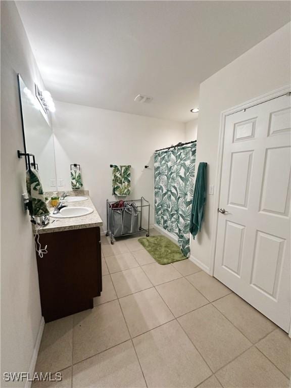 bathroom with tile patterned floors, curtained shower, and vanity