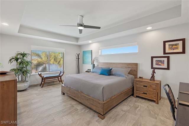 bedroom featuring a tray ceiling and ceiling fan