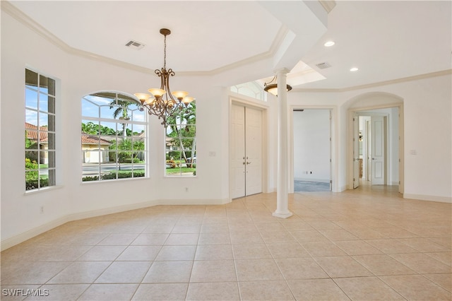 tiled spare room with a notable chandelier, ornamental molding, and decorative columns