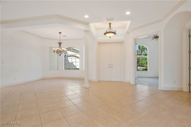 tiled entrance foyer featuring ceiling fan with notable chandelier and ornamental molding