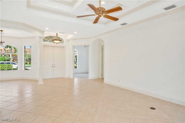 tiled empty room featuring ceiling fan with notable chandelier, a raised ceiling, and crown molding