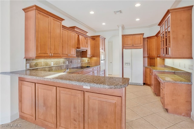 kitchen featuring kitchen peninsula, backsplash, ornamental molding, white refrigerator with ice dispenser, and light tile patterned floors