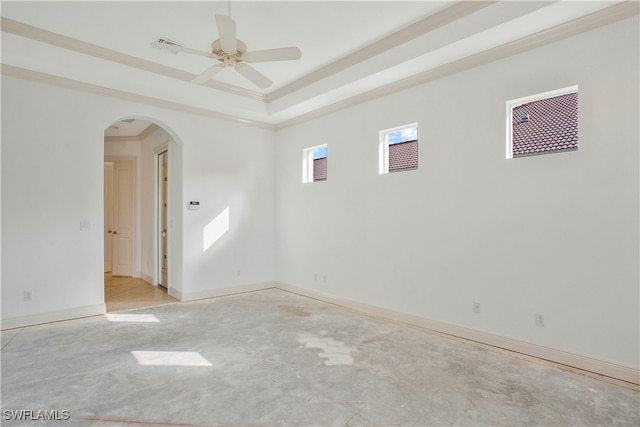 spare room featuring a raised ceiling, ceiling fan, and crown molding