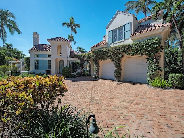 mediterranean / spanish home featuring a garage