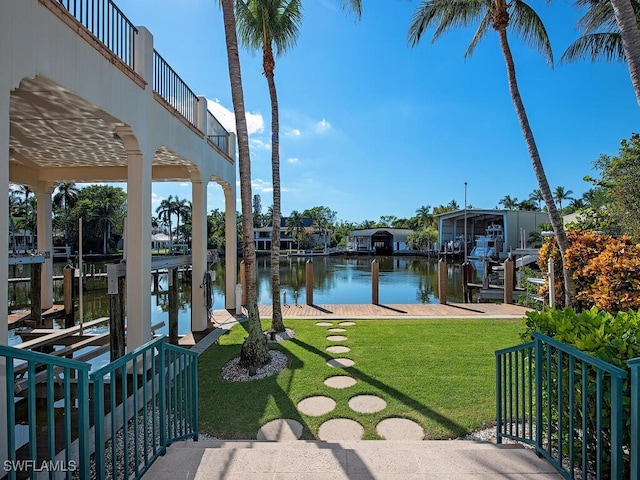 dock area featuring a lawn and a water view