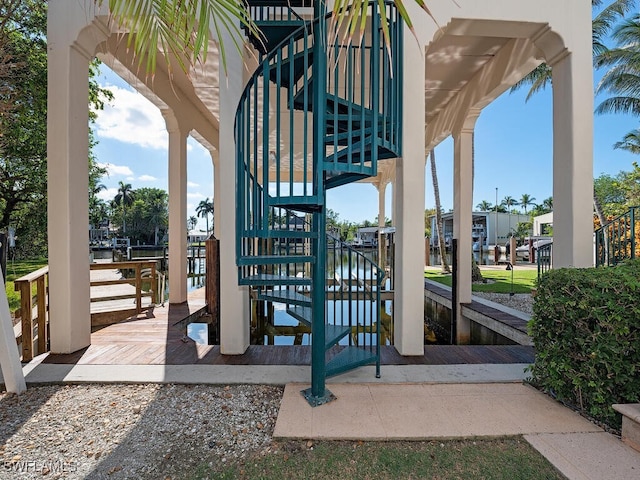 surrounding community with a boat dock and a water view