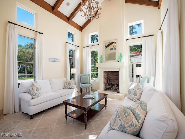 living room featuring beam ceiling, high vaulted ceiling, and an inviting chandelier