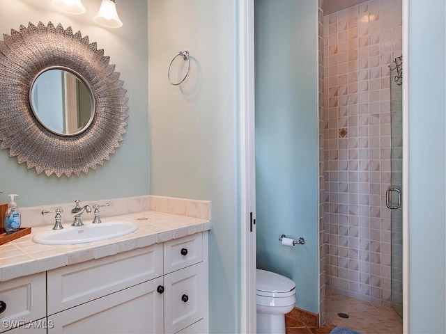 bathroom featuring walk in shower, tile patterned floors, vanity, and toilet