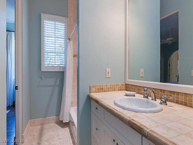 bathroom featuring vanity, shower / tub combo, and tasteful backsplash