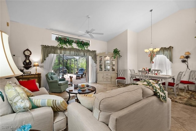 living room with light tile patterned floors, ceiling fan with notable chandelier, and high vaulted ceiling