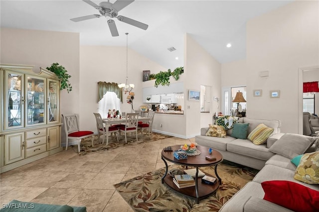 living room featuring ceiling fan with notable chandelier and high vaulted ceiling