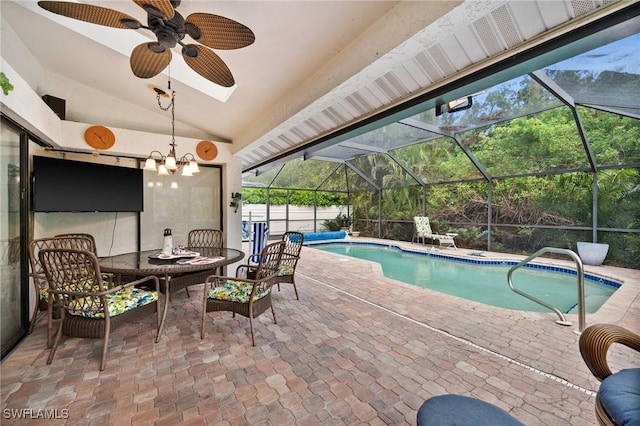 view of swimming pool with glass enclosure, ceiling fan, and a patio area